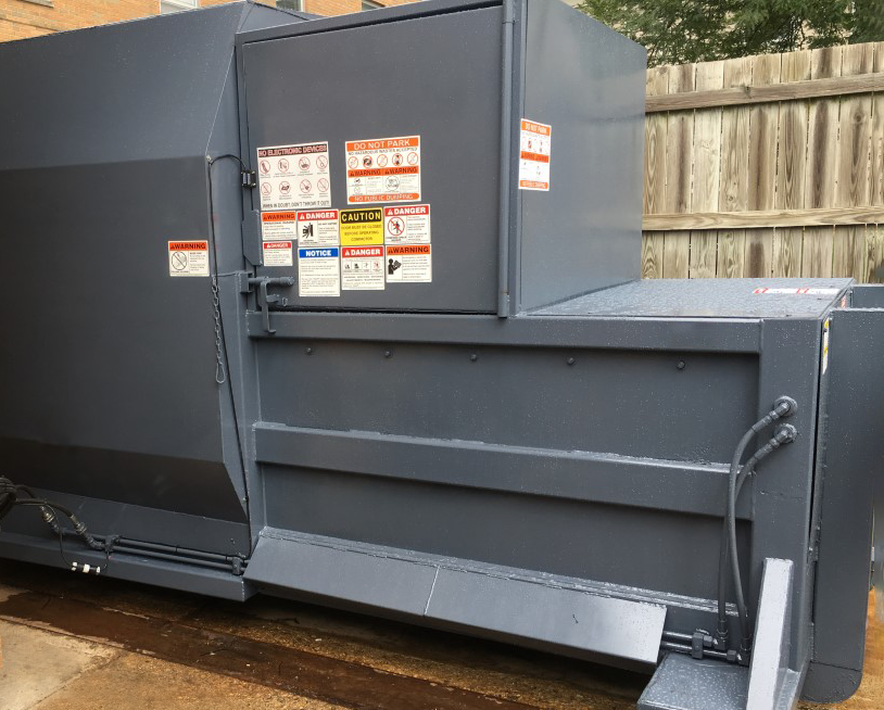 Self-Contained Compactor with Side Feed Doghouse Install from Bakers Waste Equipment Compactor Solutions